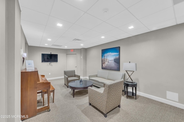 living room with visible vents, carpet flooring, a paneled ceiling, and baseboards