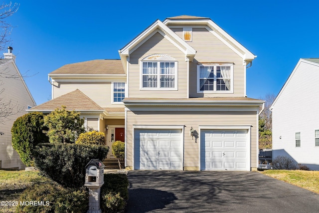 traditional home with a garage and driveway