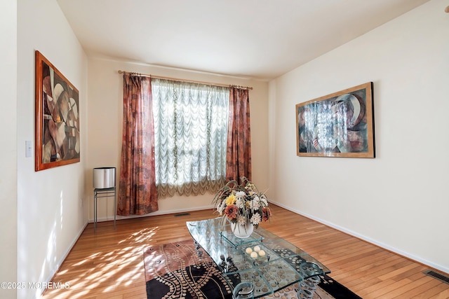 sitting room featuring visible vents, baseboards, and hardwood / wood-style flooring