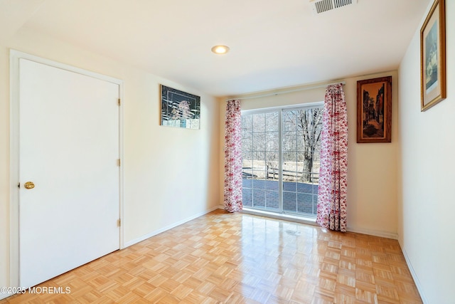 unfurnished room with visible vents and baseboards