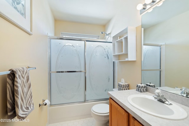 bathroom with enclosed tub / shower combo, toilet, and vanity