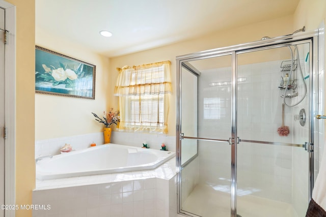 bathroom featuring a bath and a stall shower