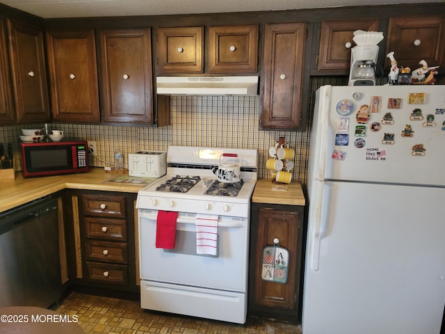 15 Wistoria Dr, Jackson, NJ 08527 - kitchen with tasteful backsplash, under cabinet range hood, dark brown cabinetry, light countertops, and white appliances