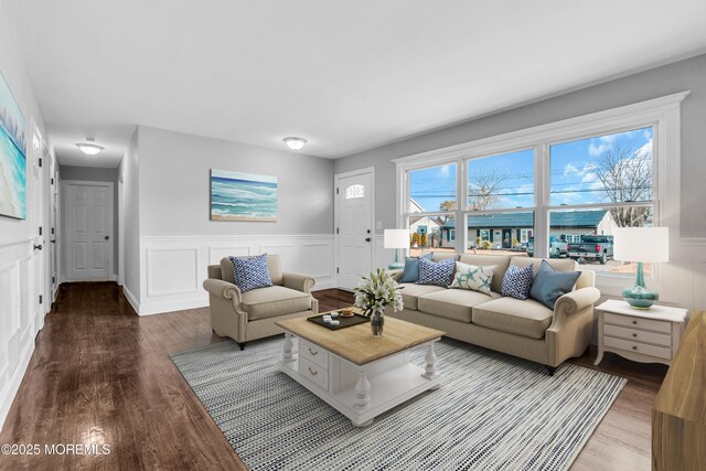 living room with a wainscoted wall and wood finished floors