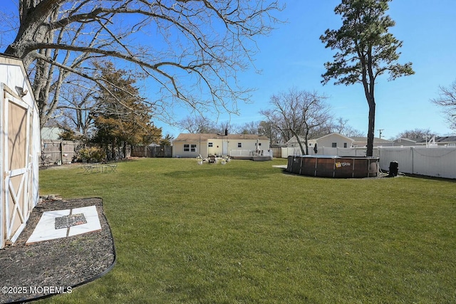 view of yard with a fenced in pool and a fenced backyard