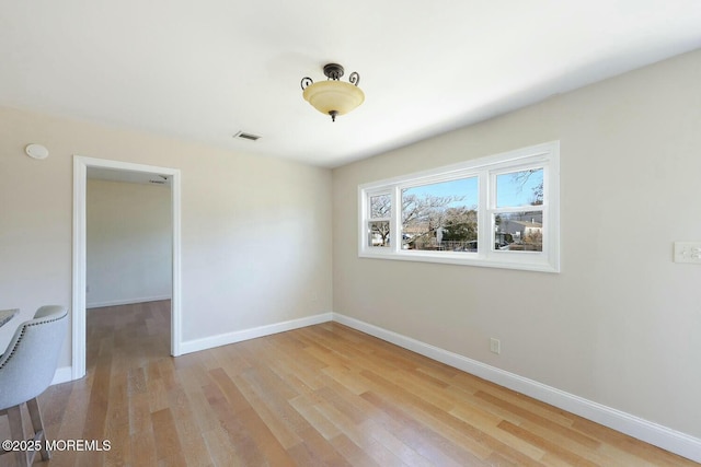 unfurnished room featuring visible vents, baseboards, and light wood-style flooring