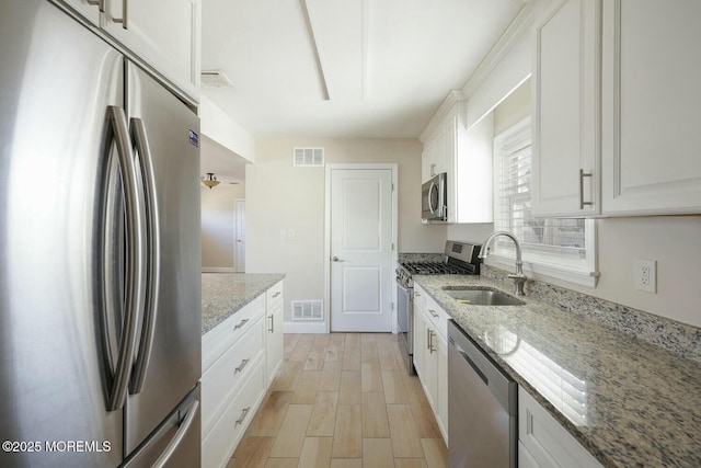 kitchen featuring a sink, stainless steel appliances, and visible vents