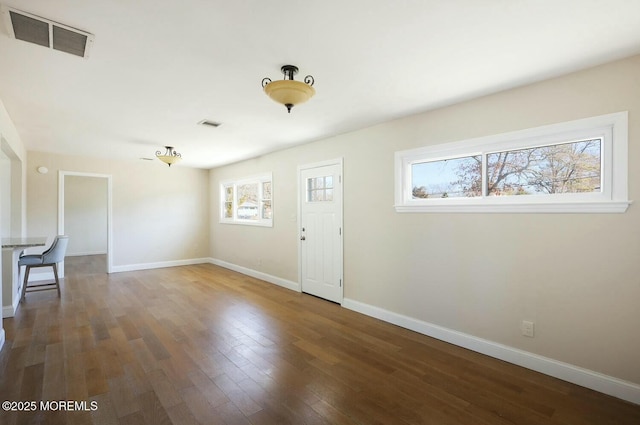 foyer with visible vents, baseboards, and wood finished floors