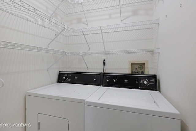 clothes washing area with laundry area and washer and dryer