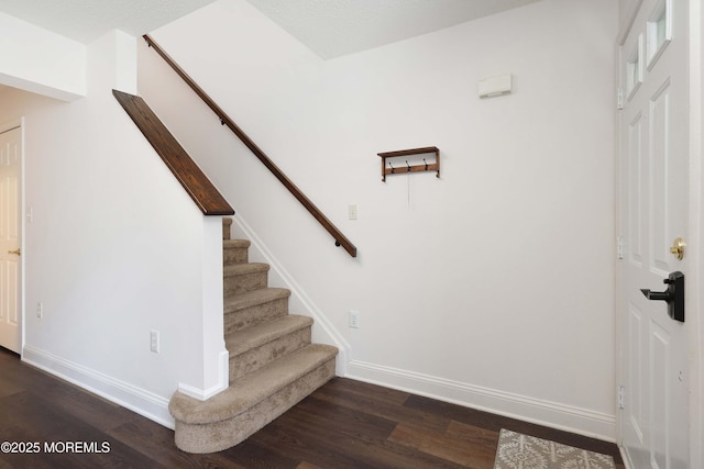 stairway with baseboards and wood finished floors