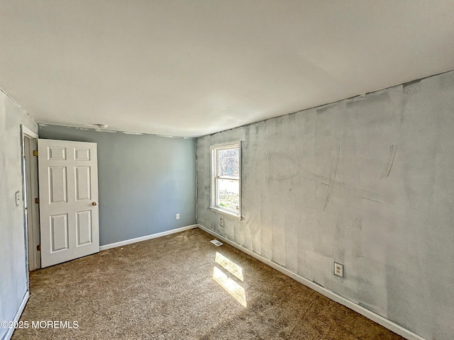 empty room with carpet flooring and baseboards