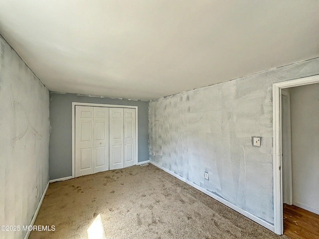 unfurnished bedroom with a closet and carpet flooring