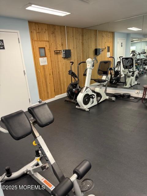 workout area featuring wood walls