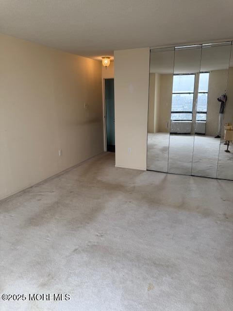 unfurnished bedroom with a closet and concrete flooring