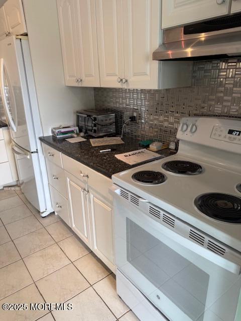 kitchen featuring light tile patterned floors, white cabinets, white appliances, and exhaust hood