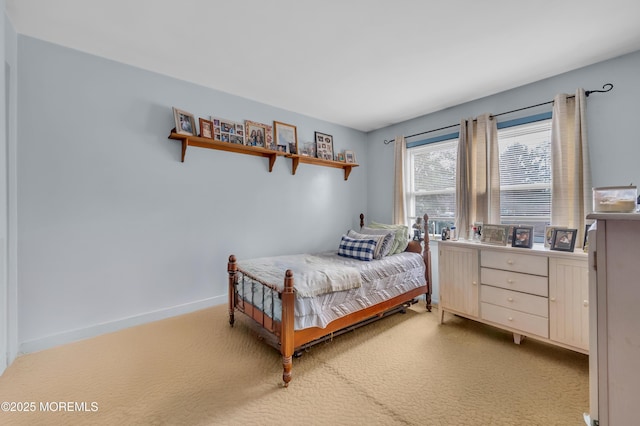 bedroom featuring baseboards and light colored carpet