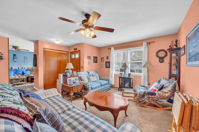 carpeted living area featuring ceiling fan and a wood stove