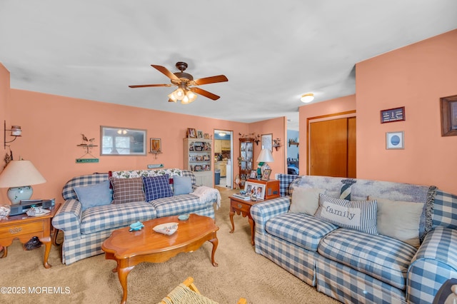 carpeted living area with a ceiling fan