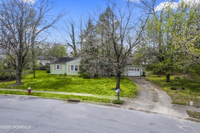 view of front of property with a garage, driveway, and a front lawn