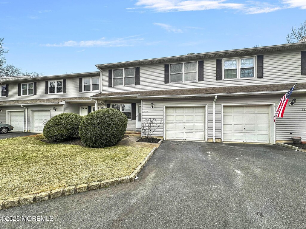 309 Sandpiper Ct, Brick, NJ 08723 - view of property featuring a front lawn, an attached garage, and driveway