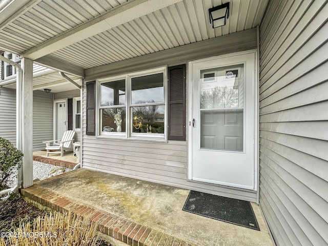 view of exterior entry featuring a porch