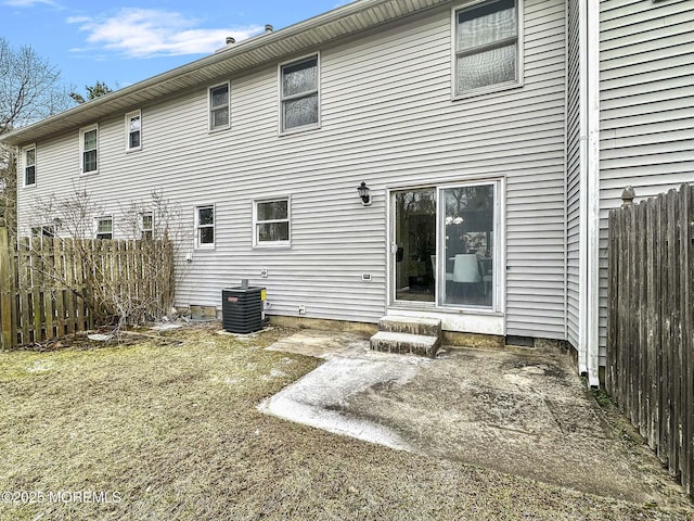 back of house featuring a patio area, central AC, and fence