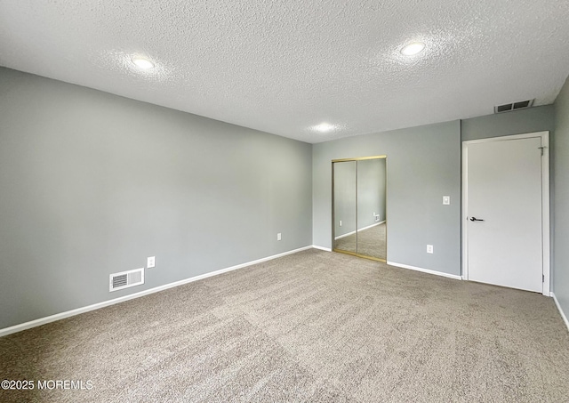 unfurnished bedroom featuring visible vents, baseboards, a closet, and carpet flooring