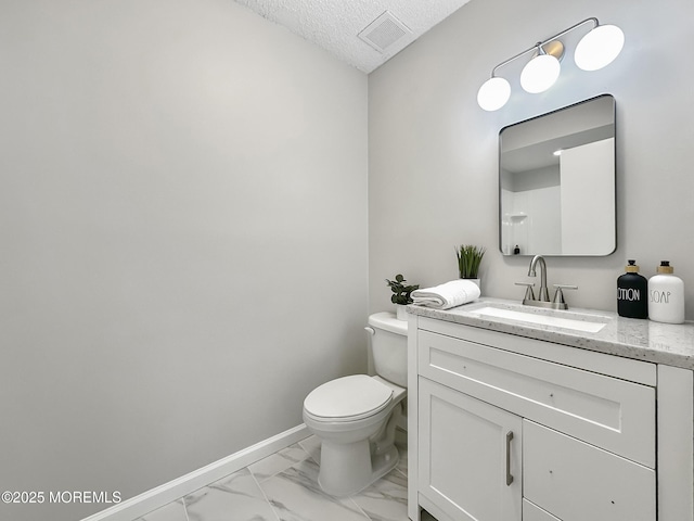 bathroom featuring visible vents, baseboards, toilet, marble finish floor, and a textured ceiling