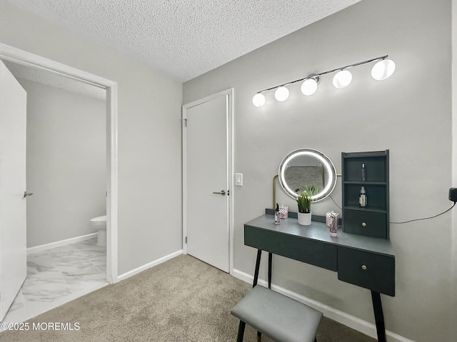 interior space with baseboards, a textured ceiling, and toilet