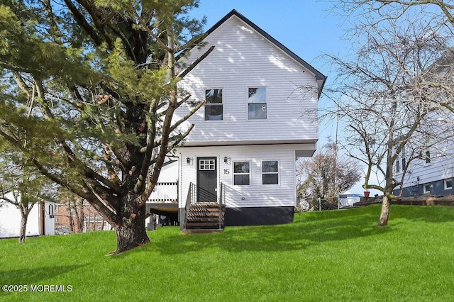 back of house with a lawn