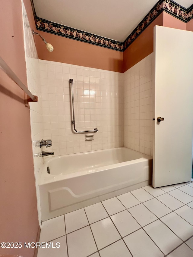 bathroom with tile patterned floors and washtub / shower combination