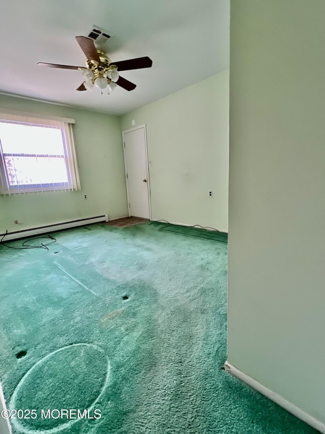 carpeted empty room featuring baseboard heating, visible vents, baseboards, and ceiling fan