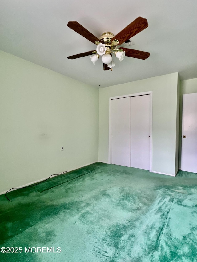 unfurnished bedroom featuring carpet, a closet, and ceiling fan