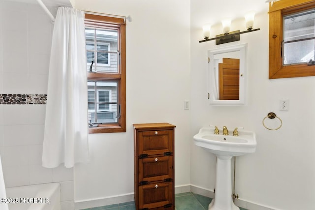 full bathroom with baseboards and shower / bath combination with curtain