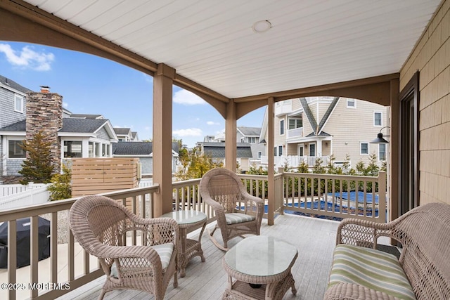 wooden terrace with a residential view, area for grilling, and fence