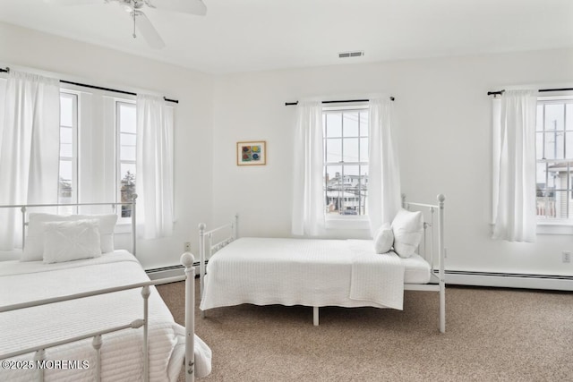 bedroom featuring ceiling fan, carpet flooring, visible vents, and a baseboard radiator