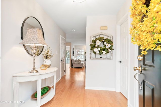 entrance foyer with baseboards and light wood-style floors