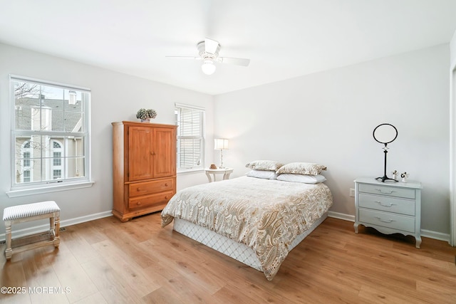 bedroom with baseboards, light wood-style flooring, and a ceiling fan