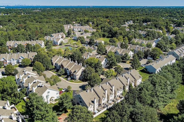 bird's eye view featuring a wooded view and a residential view