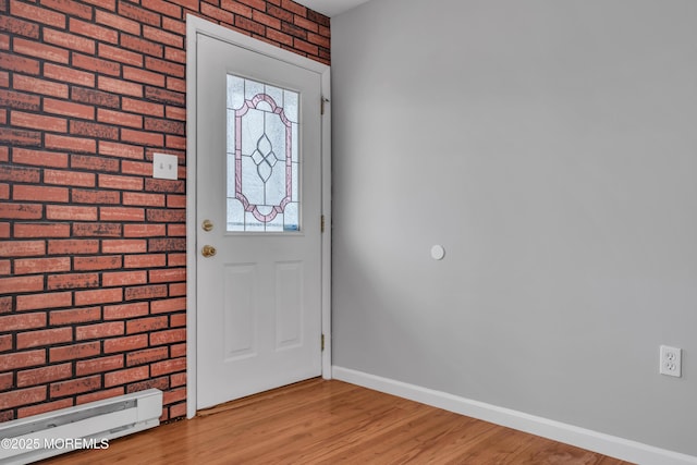 foyer with light wood-style flooring and baseboards