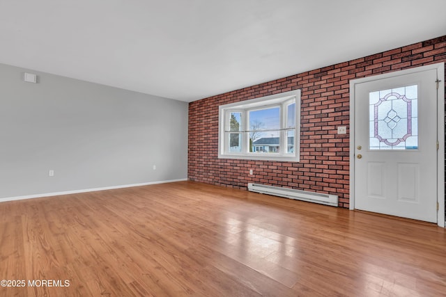 entrance foyer with light wood finished floors, baseboards, brick wall, and a baseboard radiator