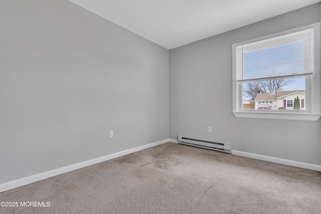 unfurnished room with a baseboard heating unit, baseboards, and carpet flooring