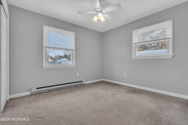 carpeted empty room with a ceiling fan, baseboards, and baseboard heating