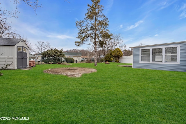 view of yard with a fenced backyard, an outdoor structure, and a shed