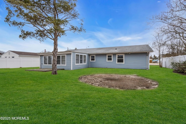 back of house featuring a patio, a lawn, and fence