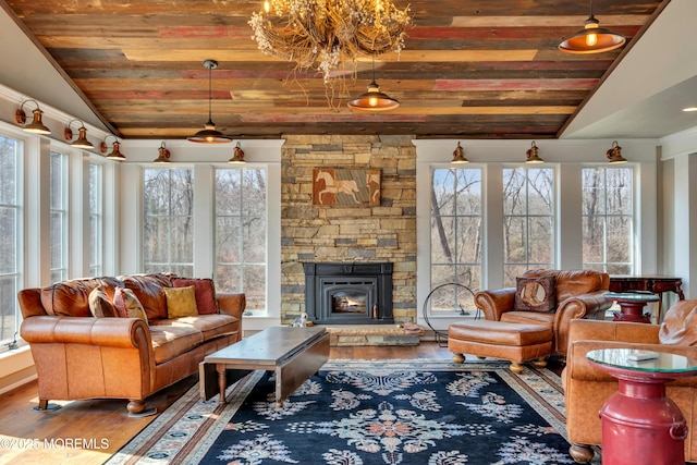 living area with a wealth of natural light, wood ceiling, wood finished floors, and vaulted ceiling