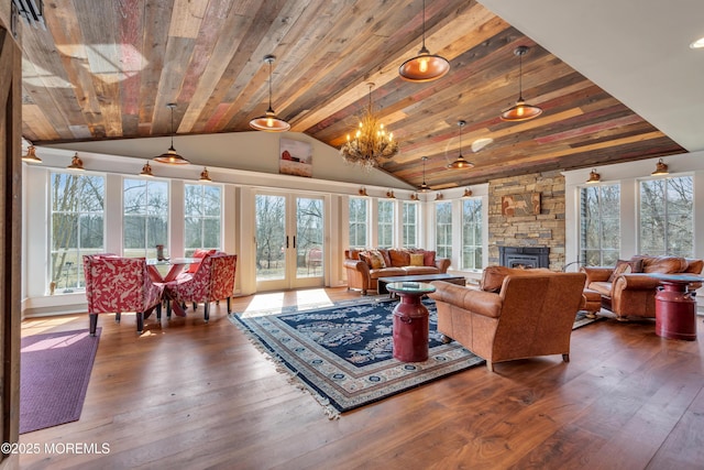 living area with vaulted ceiling, wooden ceiling, french doors, and hardwood / wood-style floors