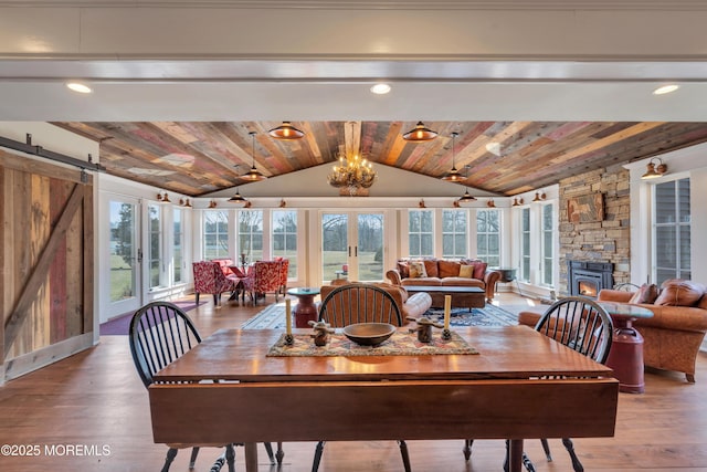 dining space with wooden ceiling, a wealth of natural light, and vaulted ceiling