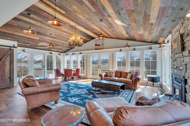 sunroom featuring a barn door, wood ceiling, and vaulted ceiling with beams