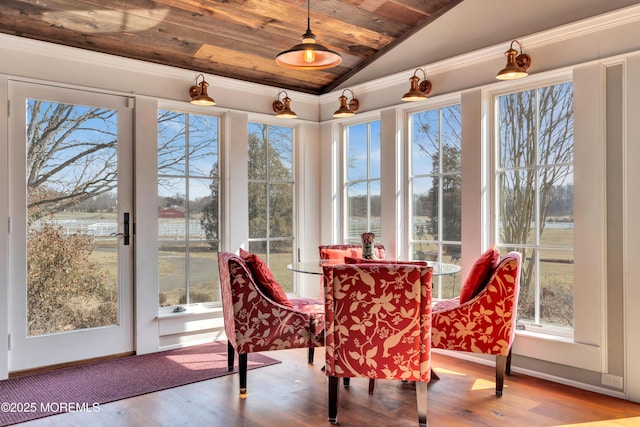 sunroom featuring lofted ceiling, plenty of natural light, and wood ceiling